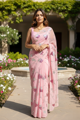 An Indian Model wearing a pink Grape vine saree by Umaid Couture, standing in a garden courtyard