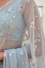 Light blue saree with floral embroidery and sequins. Product by Umaid Couture.