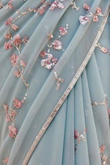 Delicate blue fabric with floral embroidery and sequin details. Product by Umaid Couture.