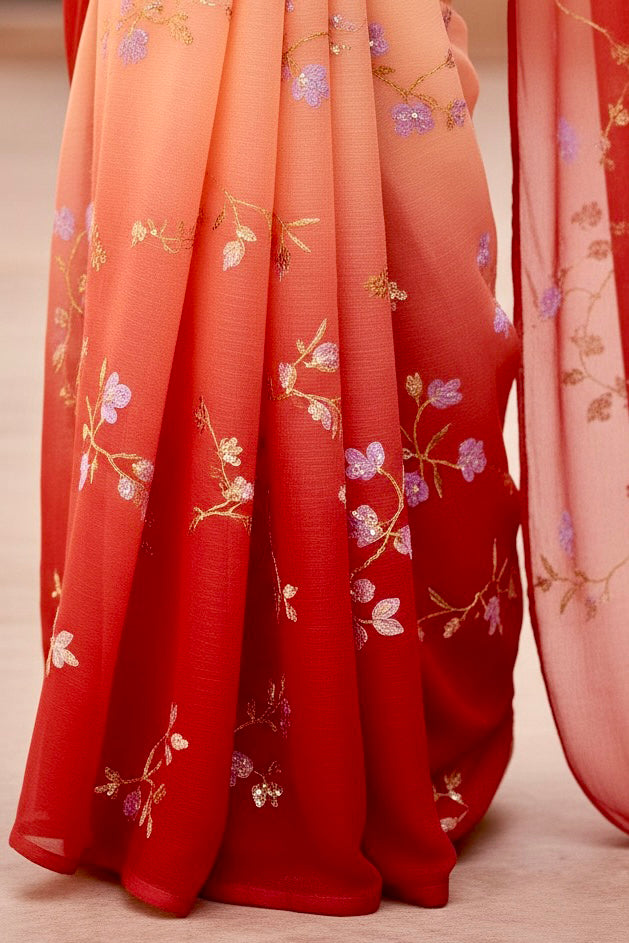 Red fabric with floral embroidery on a neutral background. Product by Umaid Couture.