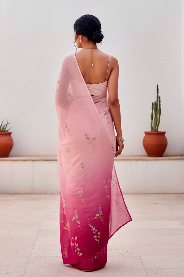 Woman wearing a pink and magenta sequins embroidered saree by Umaid Couture with a white background 