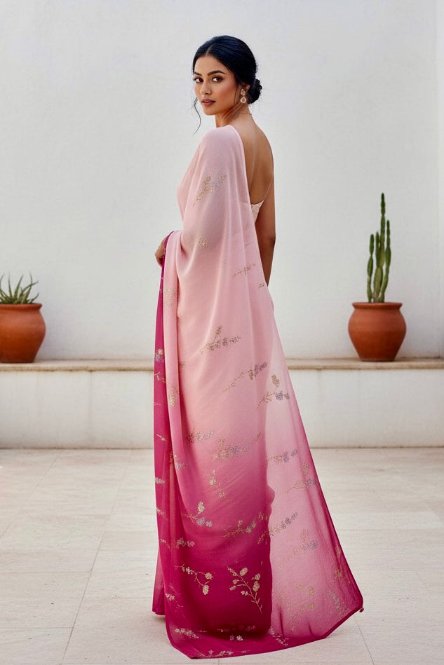 Woman wearing a pink and magenta sequins embroidered saree by Umaid Couture with a white background 