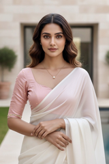 Woman wearing a white saree with pink blouse in an outdoor setting. product by Umaid Couture