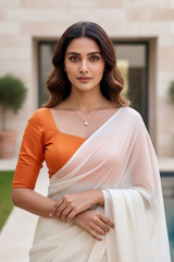 Woman wearing an orange blouse and white saree outdoors. product by Umaid Couture