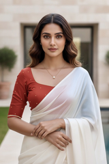 Woman wearing a red blouse and white saree with a neutral background. product by Umaid Couture