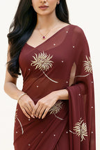 An Indian Woman in dark chocolate color saree embellished with Shevanti flower Motifs made of Gota, Zari and Sequins by Umaid Couture