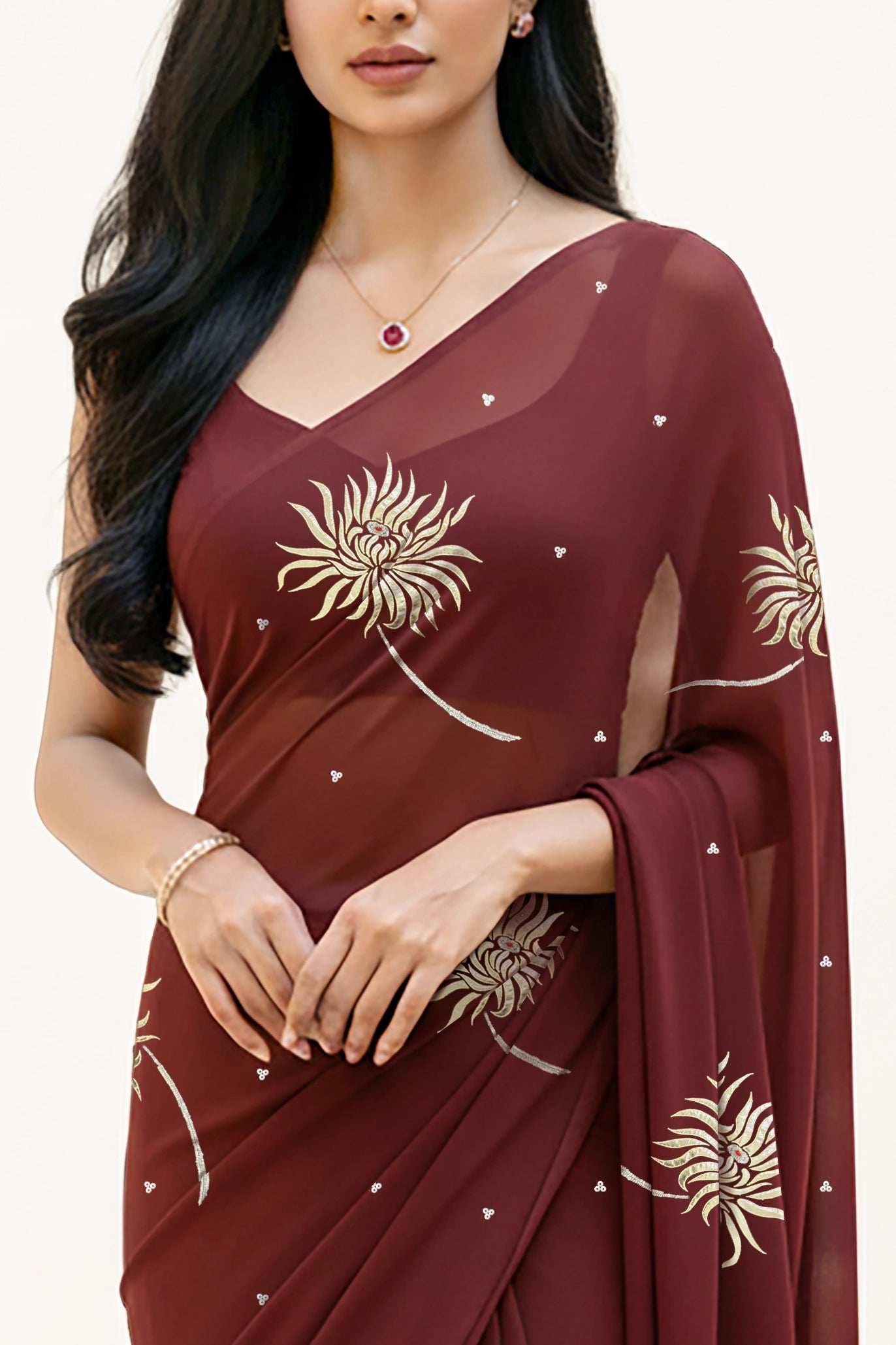 An Indian Woman in dark chocolate color saree embellished with Shevanti flower Motifs made of Gota, Zari and Sequins by Umaid Couture