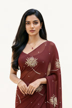 An Indian Woman in dark chocolate color saree embellished with Shevanti flower Motifs made of Gota, Zari and Sequins by Umaid Couture
