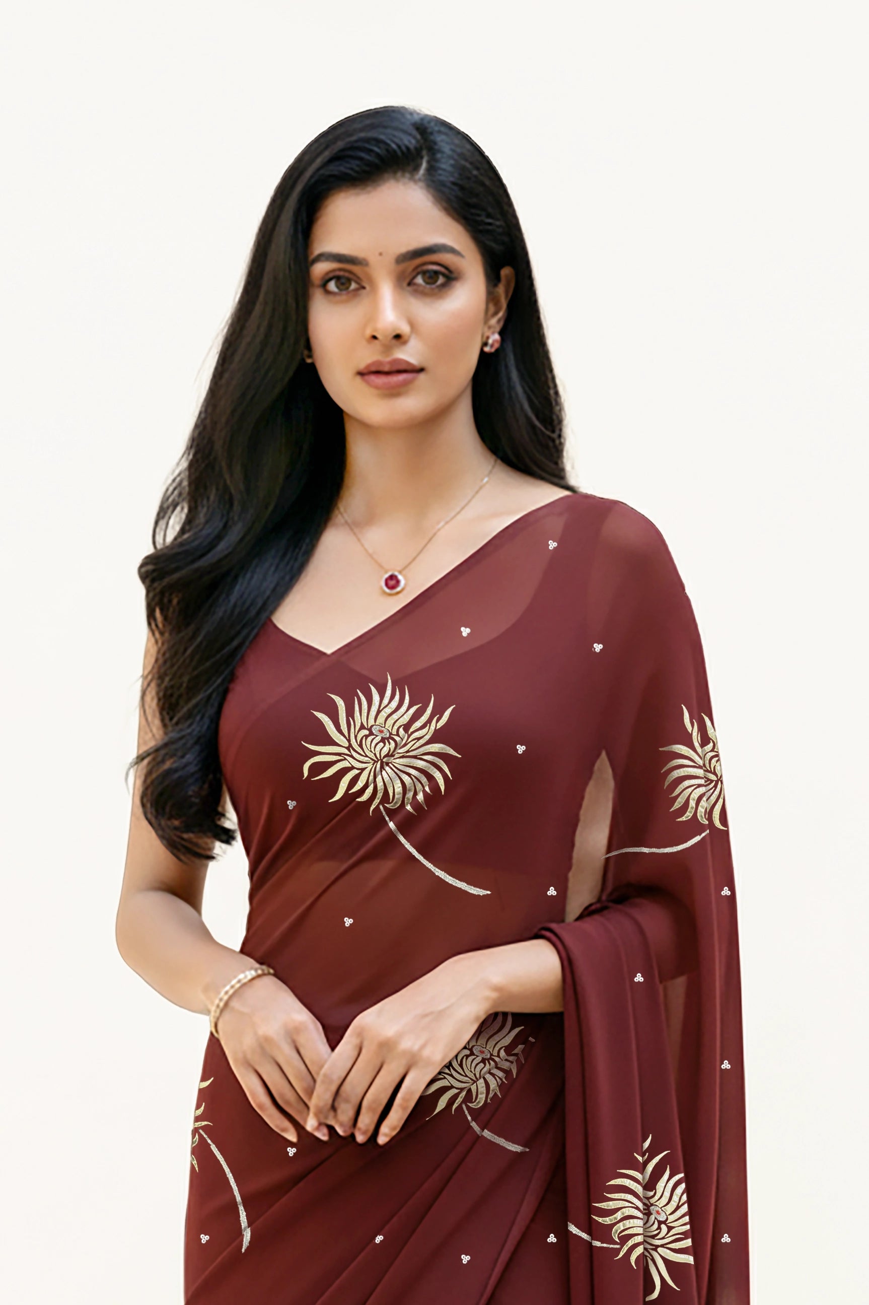 An Indian Woman in dark chocolate color saree embellished with Shevanti flower Motifs made of Gota, Zari and Sequins by Umaid Couture