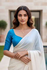 Woman wearing a blue blouse and white saree outdoors. product by Umaid Couture