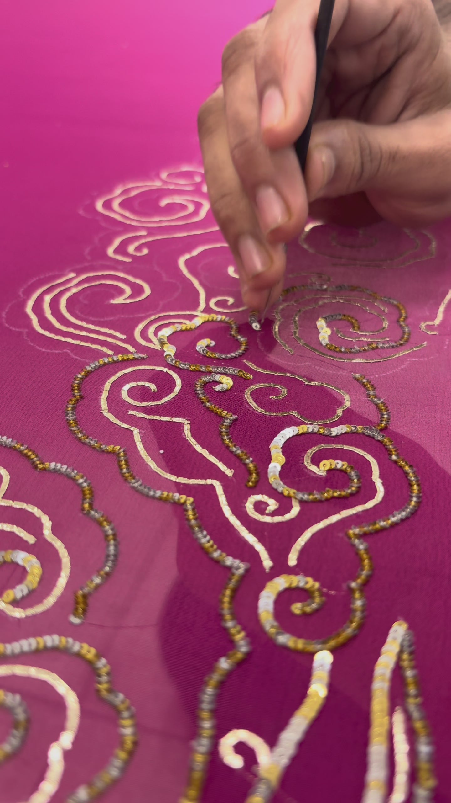  making video of crimson red saree with artistic cloud vines border on saree made by umaid couture.