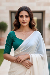 Woman wearing a green blouse and white saree outdoors. product by Umaid Couture