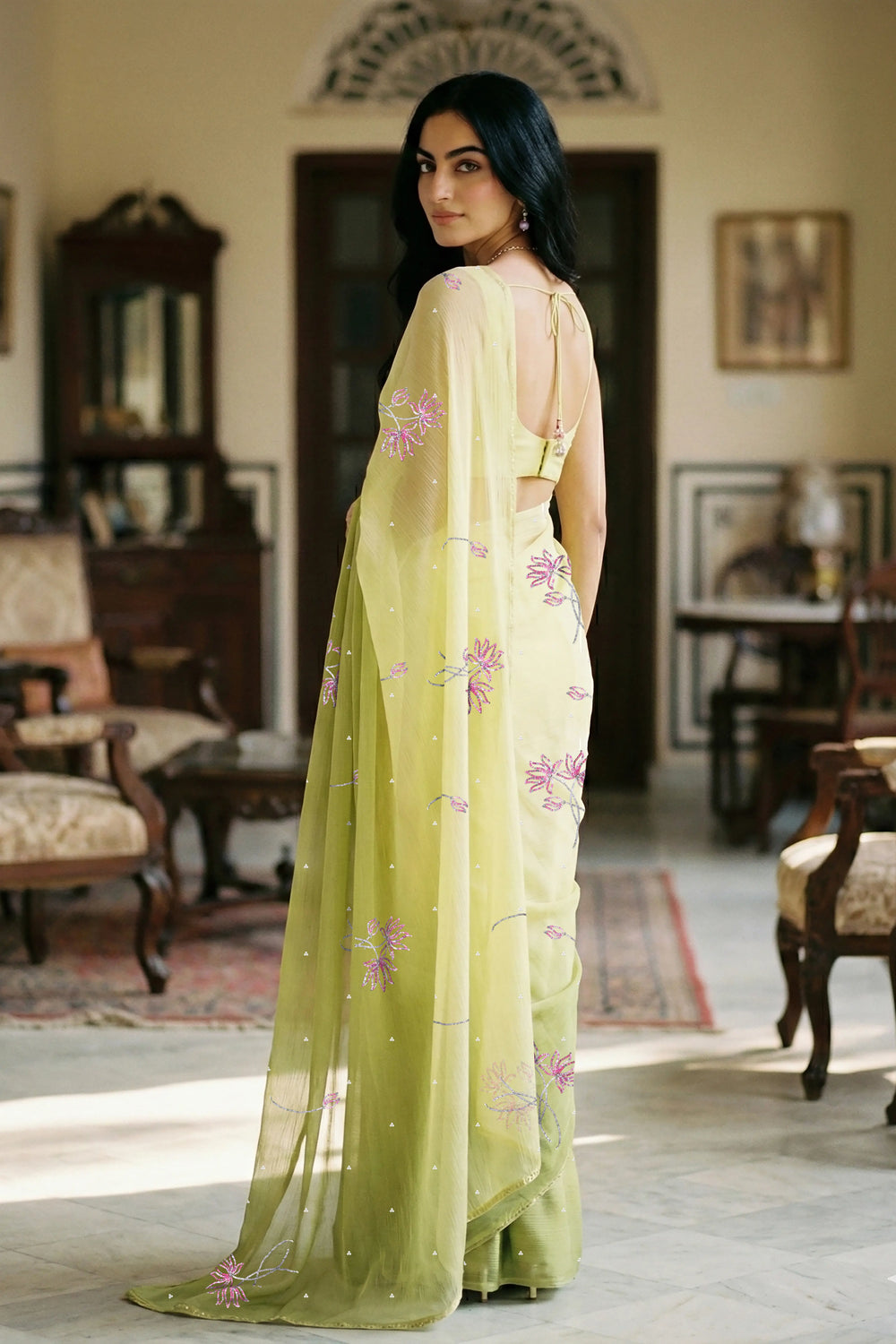 woman in green gradient saree with beautiful lotus motif made with pink and silver sequins and finely done with aari-zardosi made by umaid couture.